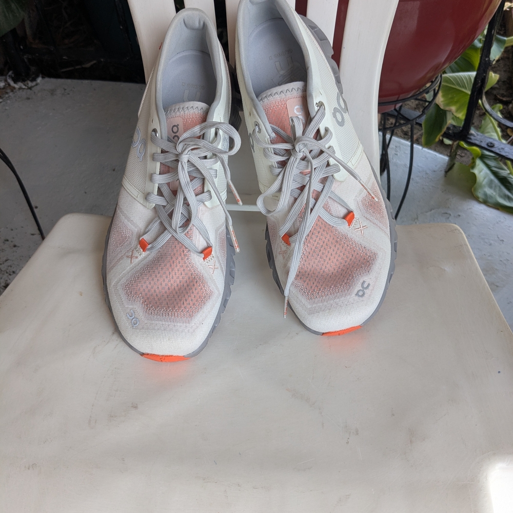 On Running White and Orange Athletic Shoes